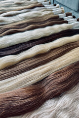 Hair extensions are on the table. Natural hair. Capsule hair extension. Beauty salon. Soft focus