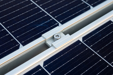 Close up on The clamp is fixed in the middle between the solar panels.