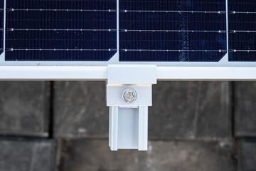 Close up on the clamp at the edge of the solar panel. © Chumphon_TH