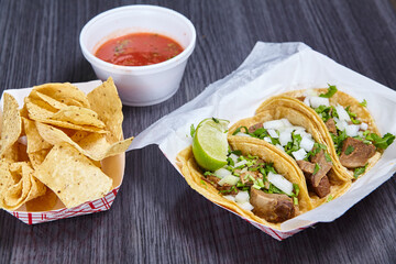 Chips red salsa street taco meal 3 corn tortilla lengua cow beef tongue Mexican lime wedge