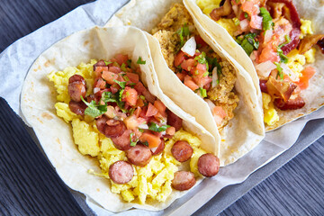 3 flour tortilla Mexican breakfast tacos sausage chorizo bacon with toppings asset