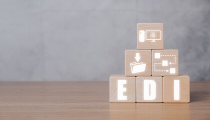 EDI, Electronic data interchange concept, Wooden block on desk with Electronic data interchange icon on virtual screen.
