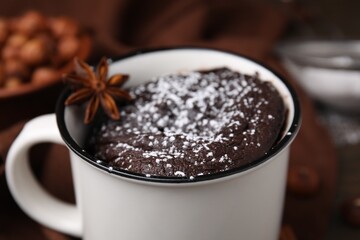 Tasty chocolate mug pie with anise on table, closeup. Microwave cake recipe