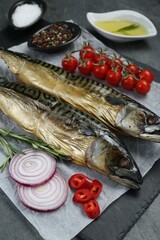 Delicious smoked mackerels and products on grey table, closeup