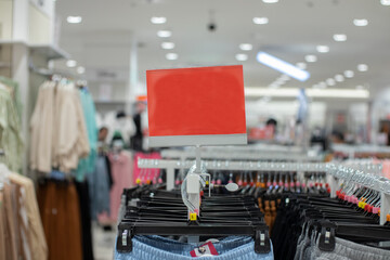 selective focus to blank red board for women's and men's clothing discount template in mall. soft focus