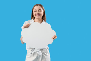 Happy young woman with blank speech bubble on blue background