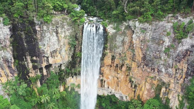 Aerial view of Purling Brook falls, with a wide zoom out to reveal Springbrook National park surrounds and lower pool. Gold Coast hinterland