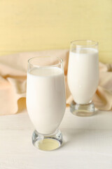 Glasses of fresh milk on table
