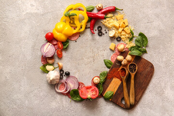 Frame made of ingredients for preparing pizza on grey background