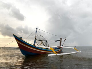 twilight atmosphere on the seashore with fishing boats docked