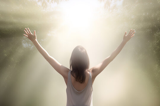 A Woman Standing In The Middle Of The Forest With Arms Outstretched In The Bright Morning Sunray