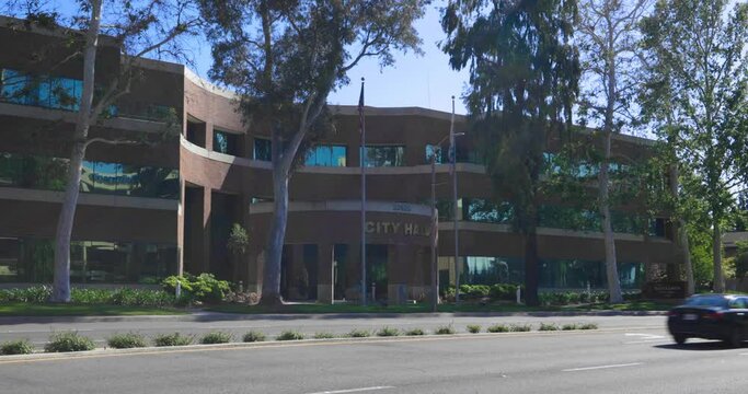 The Santa Clarita City Hall building, located in northern Los Angeles County. Real-time static shot on a late, sunny afternoon with traffic passing by.