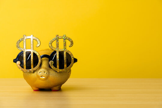 Piggy bank wears glasses with dollar sign