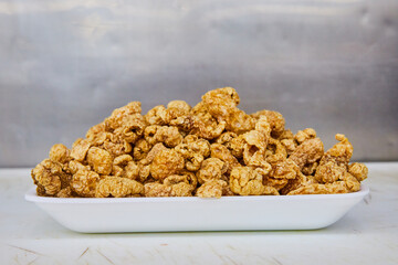 Chicharrones in white tray piled high