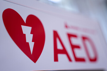 An automated external defibrillator (AED) in a white box is an emergency defibrillator for people in cardiac arrest. blurry concept