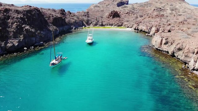 Blue Ocean and Private Island at Loreto Mexico, A yatch and a sailboat in a beautiful sunny day, clearwater, fishing day, at Sea Of Cortez, smooth dolly in,