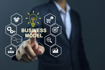 Business man pointing to the business model infographic the analyse or planing business factor.