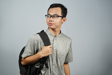 Portrait of a man wearing glasses with black backpack.