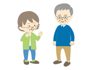 眼鏡をしたシニアの男性と眼鏡をしたシニアの女性が立ち話をしている様子