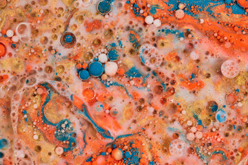 Colors like vomit settle in abstract acrylic pour with bubbles of color in horizontal background...