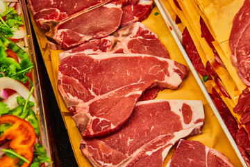 Horizontal row of raw t-bone steaks asset - Powered by Adobe
