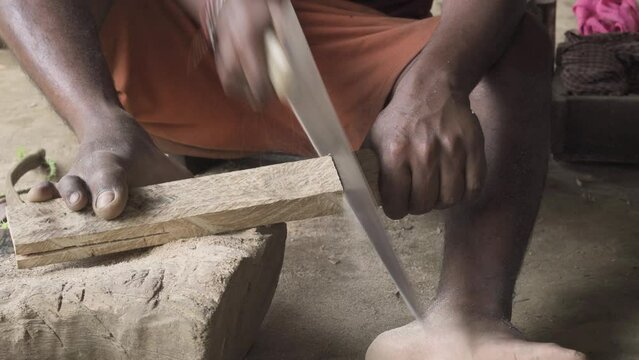 Manual handsaw chopping by a indian carpenter for a living
