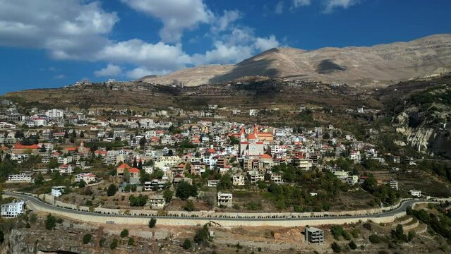 Wide angle establishing drone shot Bsharri town on mountain in Lebanon
