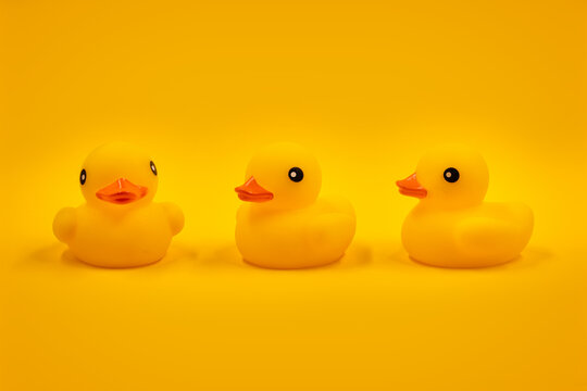 Yellow rubber ducks and one in a row