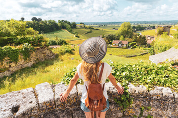 Rear view of woman looking at green vineyard in Bordeaux region, Saint Emilion- France, Nouvelle...