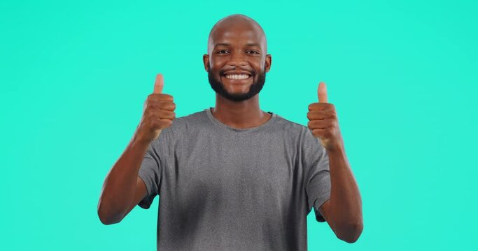 Happy, face and black man with thumbs up in studio isolated on a blue background mockup space. Portrait, like hand gesture and African male person with emoji for success, review or thank you for vote