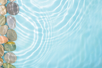 stones with sun lights shadow in ripple water over abstract blue background, beautiful abstract space background concept, copy space