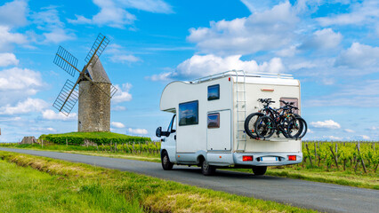 Fototapeta Family travel- Road trip in motorhome-vineyard and windmill- France, Bordeaux region, Nouvelle aquitaine obraz