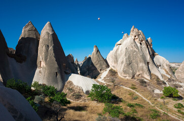 Rock formations of Cappadocia with cave dwellings in Goreme National Park, fabulous cone shaped Fairy Chimneys, incredible nature of Turkey
