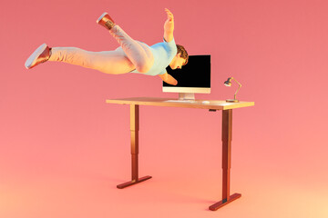 businessman floating in air gets sucked into pc display; surreal stress immersion and virtual reality concept; isolated desk on infinite background; 3D Illustration