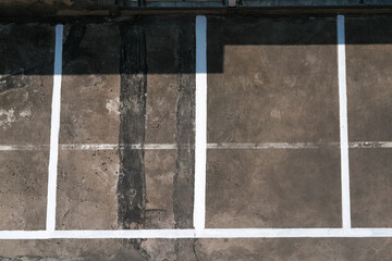The parking lot is painted with white lines as spaces for cars to park in order.