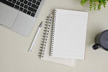 Minimal workspace with an empty page on a diary on a grey background. top view