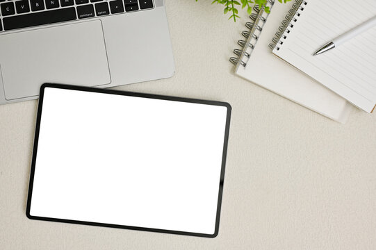 Minimal office desk workspace top view with digital tablet white screen mockup