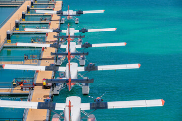 New floating dock at Male airport. Trans Maldivian Airways Twin Otter seaplanes. Exotic scene, seaplanes in calm ocean lagoon. Luxury travel vacation view. Transportation tourism background concept