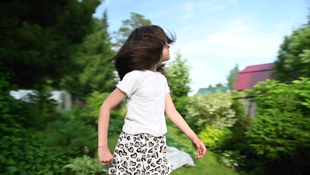 Little girl plays with an airplane outdoors. Video 360 degrees.