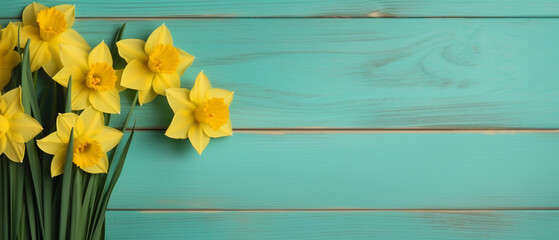 Yellow flower on turquoise wood background with copy space