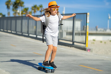 Boy on skateboard skating. Child skateboarding at park in the city. Kid boy enjoy and having fun...