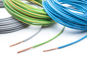 Electrical wires: phase, neutral and ground on white background, close-up.