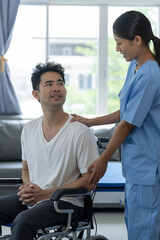 Rehabilitation specialist or physiotherapist giving physical training instruction to male patient in wheelchair at rehabilitation center The concept of physical therapy and health insurance.