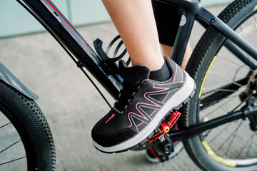 Photo of a girl doing bicycle exercise, and wearing sports shoes   