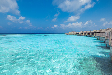 Panoramic landscape of Maldives beach. Exotic vacation seascape water villas bungalows resort with...