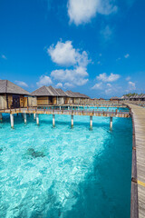 Panoramic landscape of Maldives beach. Exotic vacation seascape water villas bungalows resort with wooden pier bridge. Luxury travel destination. Fantastic turquoise blue ocean lagoon bay sunny sky