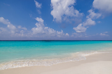Sunny closeup of sea sand beach blue summer sky. Panoramic beach landscape. Tranquil relaxing...