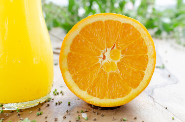 glass jar of fresh orange juice with fresh fruits on wooden table