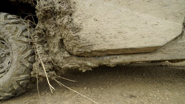 Low close shots of muddy UTV in ranch yard in Montana