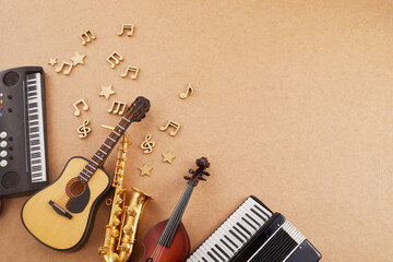 Happy world music day. Musical instruments on brown background.